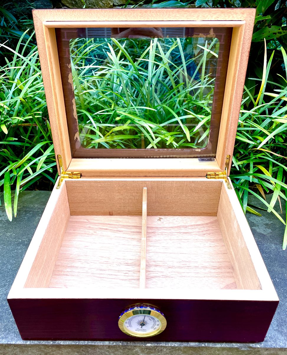 The same humidor, open, showing the Spanish cedar lining and the divider.